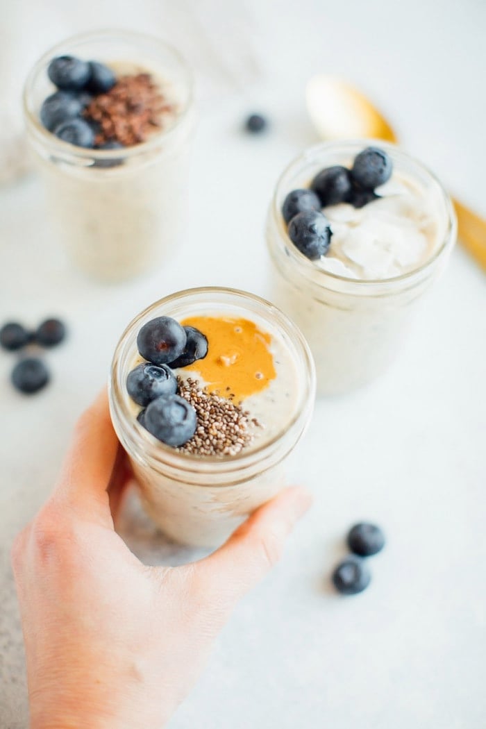 Grain-Free overnight "oats" in a jar being held by a woman's hand. 