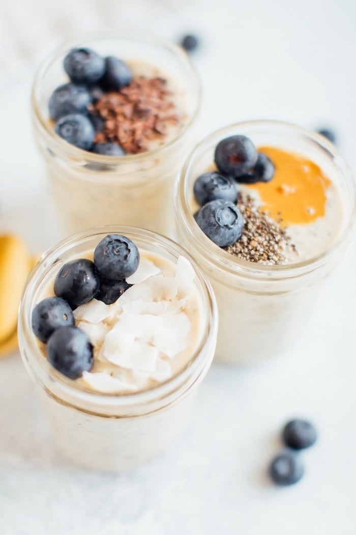 Up close shot of grain-free overnight "oats" topped with coconut flakes and blueberries.