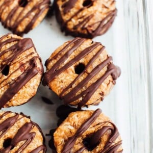 Homemade 4-Ingredient Samoas Girl Scout cookies in a glass storage container.