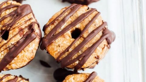 Homemade 4-Ingredient Samoas Girl Scout cookies in a glass storage container.