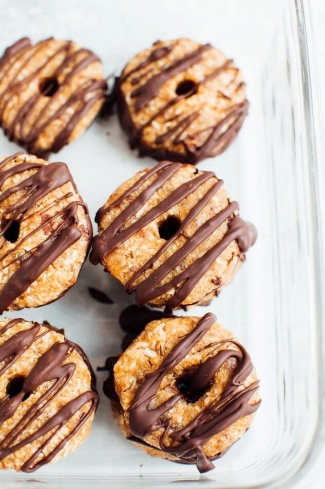 Homemade 4-Ingredient Samoas Girl Scout cookies in a glass storage container.