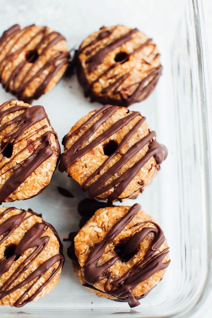 Homemade 4-Ingredient Samoas Girl Scout cookies in a glass storage container. 