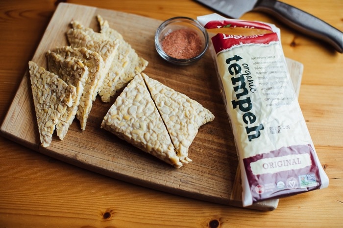 Slices of tempeh being sliced and prepped for making bbq tempeh chips. 