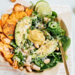 Loaded sweet potato nacho salad bowls bowls with sweet potato chips, baby spinach, jalapeño and fresh herbs.