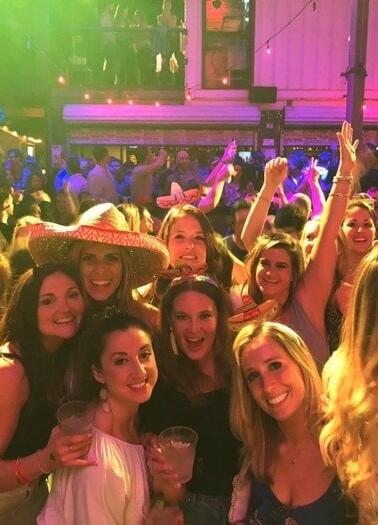 Group of woman smiling at a club.