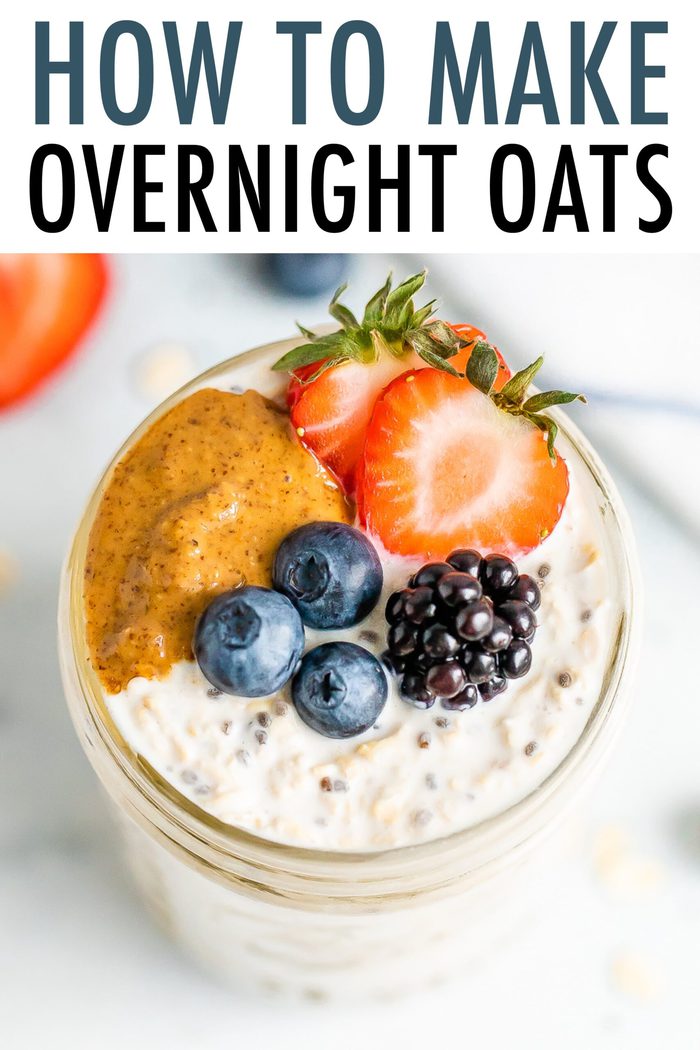Top view of a jar filled with overnight oats and topped with berries and peanut butter.