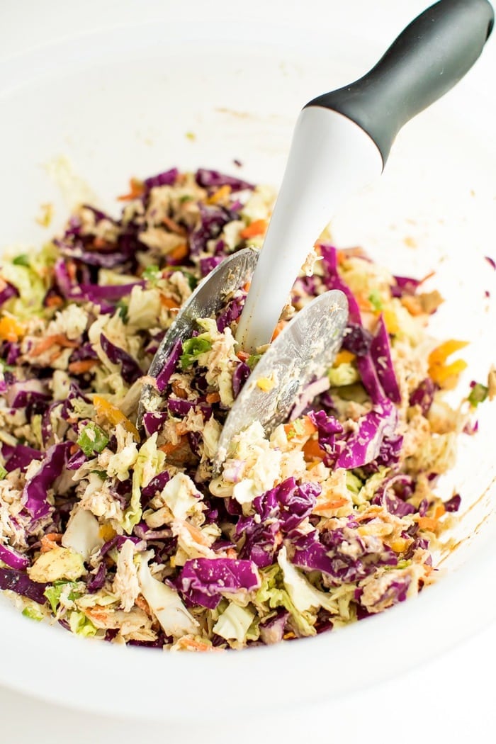 Asian salad being chopped in an OXO salad chopper bowl. 