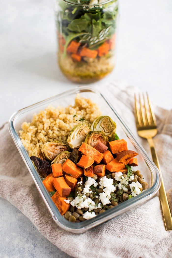 Meal prep salad with red wine vinaigrette quinoa, lentils, roasted brussels sprouts, roasted sweet potatoes, kale and feta.