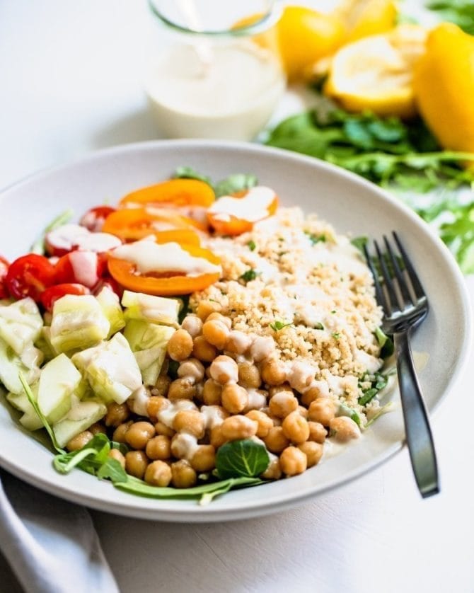 Chickpea Couscous Bowls -- bowls with cucumber, chickpeas, couscous and tomatoes on greens.