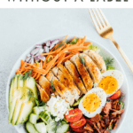 Photo of a chicken Cobb salad, with avocado, onion, carrots, cucumber, egg, tomatoes, and bacon. Text reads "healthy Eating without a Label"