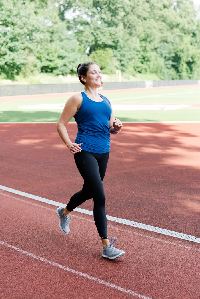Women running on track wearing Athleta Run Free workout gear.