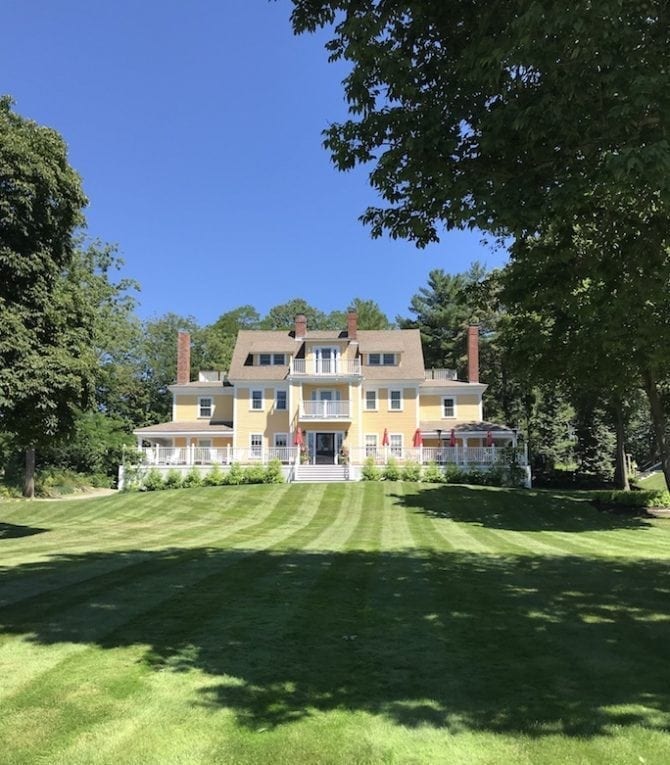 View of the York Harbor Inn with lush and expansive green lawn.