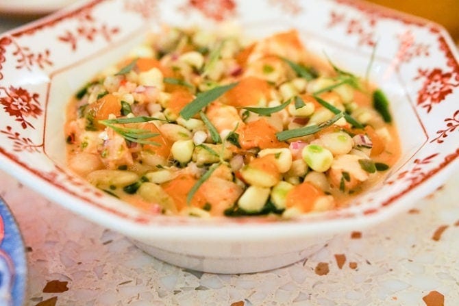 China bowl filled with beans and chopped veggies.