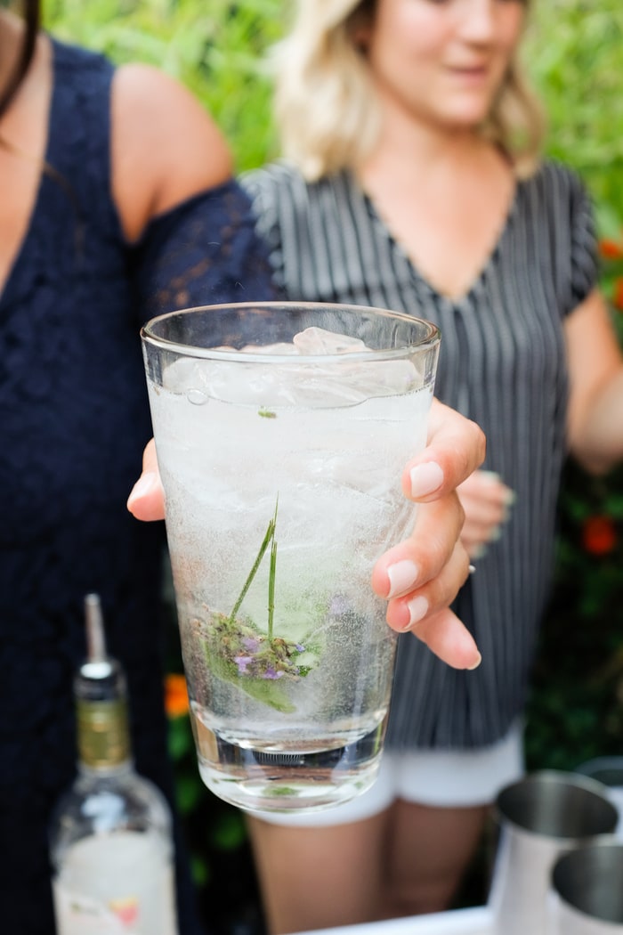 Woman holding a Vodka Soda with Ketel One Botanicals