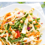 Plate of pad thai salad with kale, cabbage and chickpeas. Text on the image says "Kale + Cabbage Pad Thai Salad"