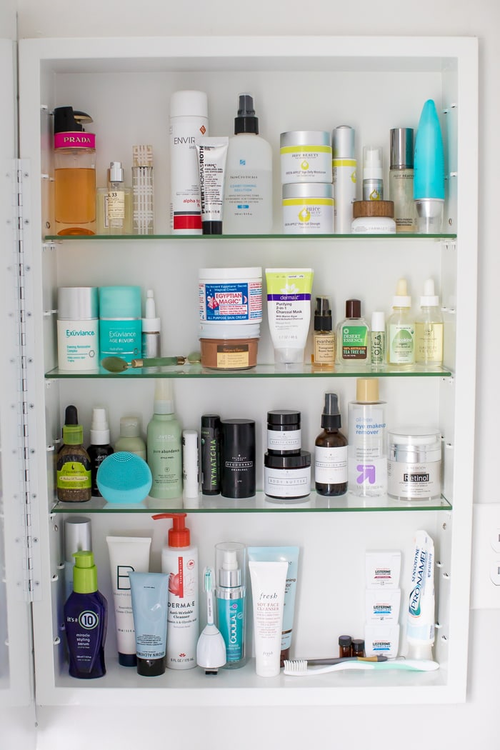 Organized medicine cabinet with skin, hair and beauty items.