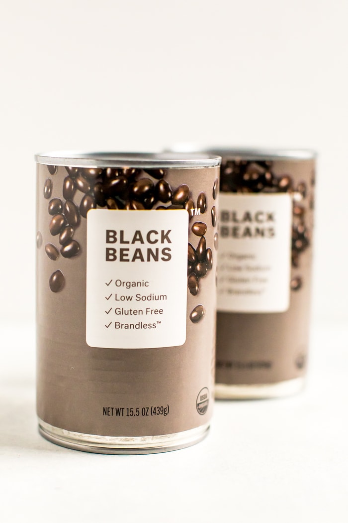 Two cans of Brandless black beans.