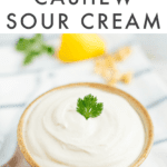 Bowl of cashew sour cream topped with an herb.