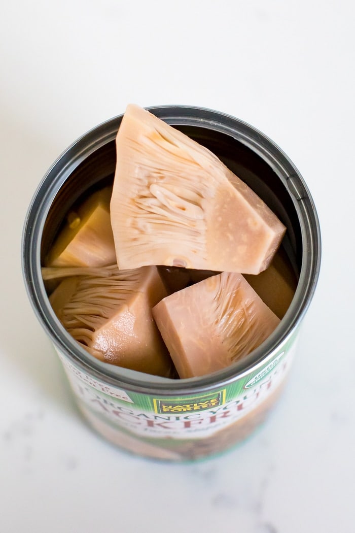 Close up of jackfruit in a can with the lid off.