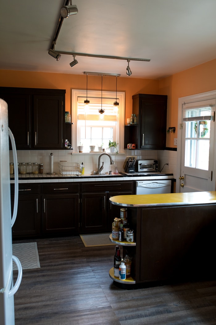 View of a kitchen island with wall cabinets behind it.