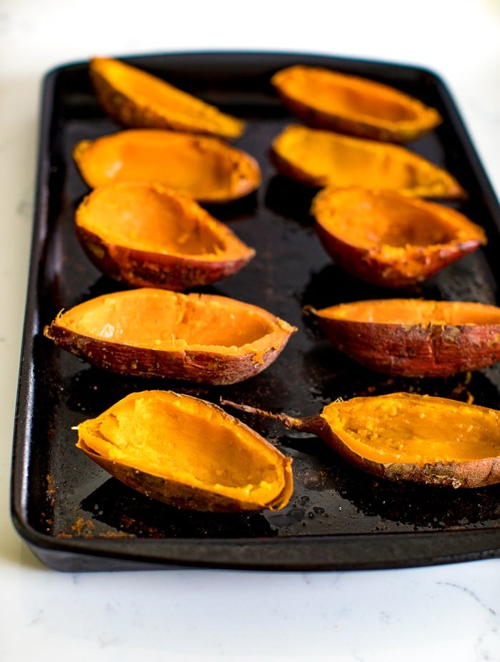 Baked sweet potato skins on a baking stone ready for filling.