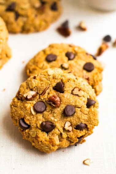 Healthy sweet potato breakfast cookies on a table, make with oats, pecans, and chocolate chips.