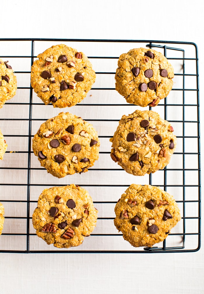 Healthy sweet potato breakfast cookies on a cooking rack made with chocolate chips, oats and chopped pecans.