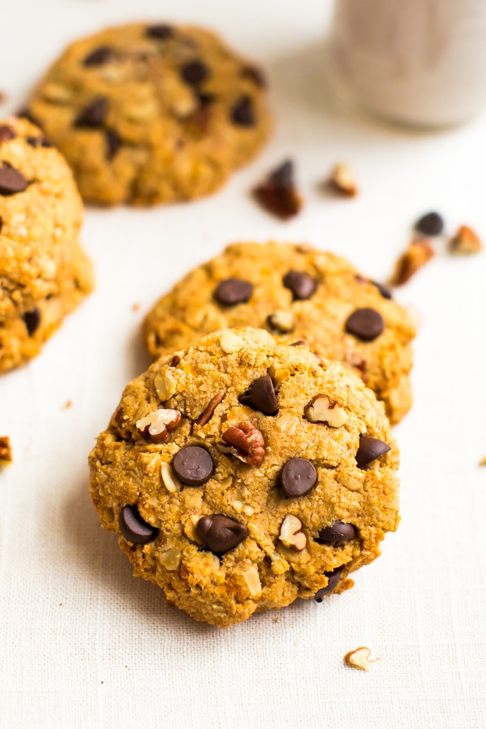 Healthy sweet potato breakfast cookies on a table, make with oats, pecans, and chocolate chips.