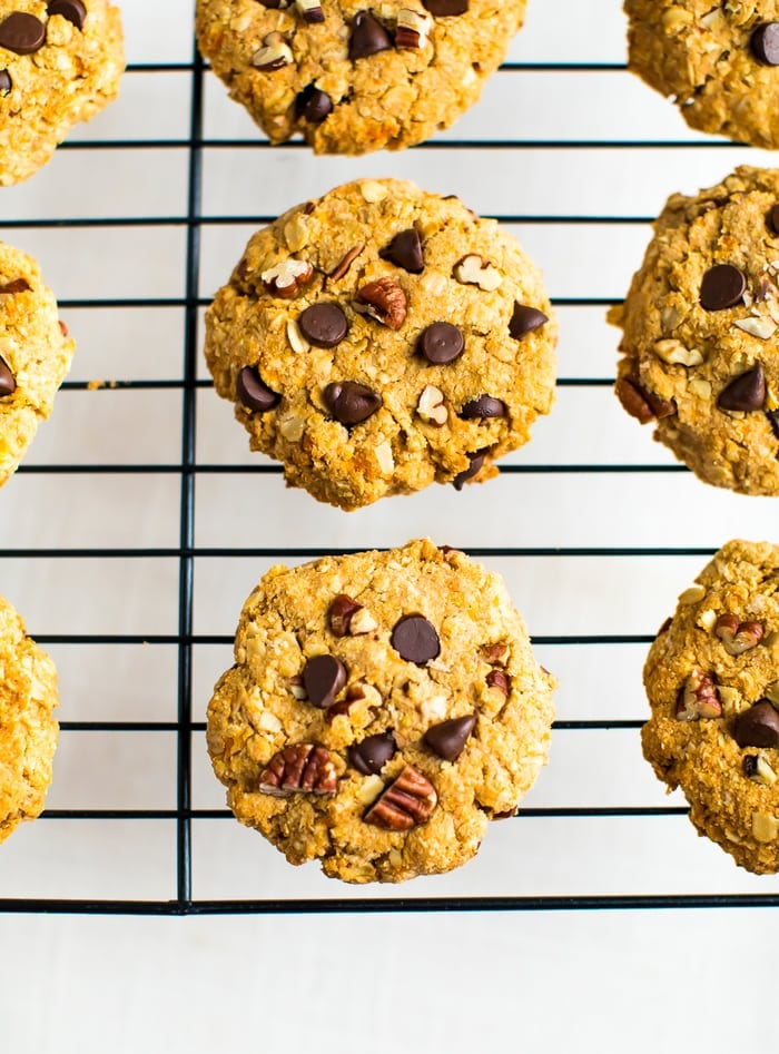 Healthy sweet potato breakfast cookies on a cooking rack made with chocolate chips, oats and chopped pecans.