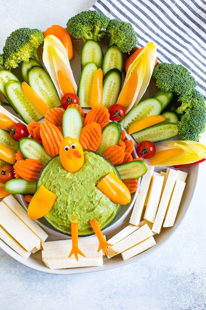 Cute turkey thanksgiving veggies tray. Veggies formed to look like a cute turkey as a veggie tray, with a bowl of guacamole.