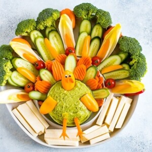 Cute turkey thanksgiving veggies tray. Veggies formed to look like a cute turkey as a veggie tray, with a bowl of guacamole.