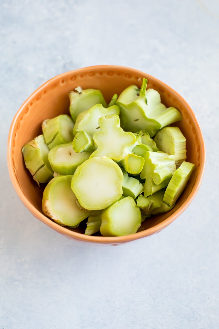 Broccoli stalks chopped into pieces and sitting in a bowl.