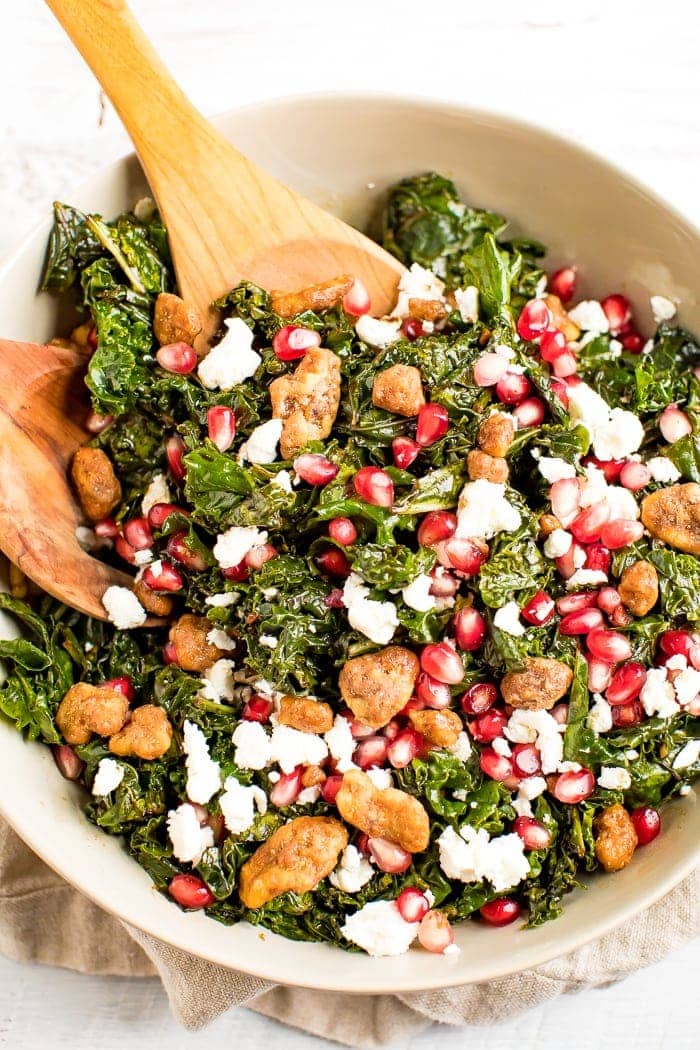 Christmas kale and pomegranate salad with goat cheese topped with candied nuts.