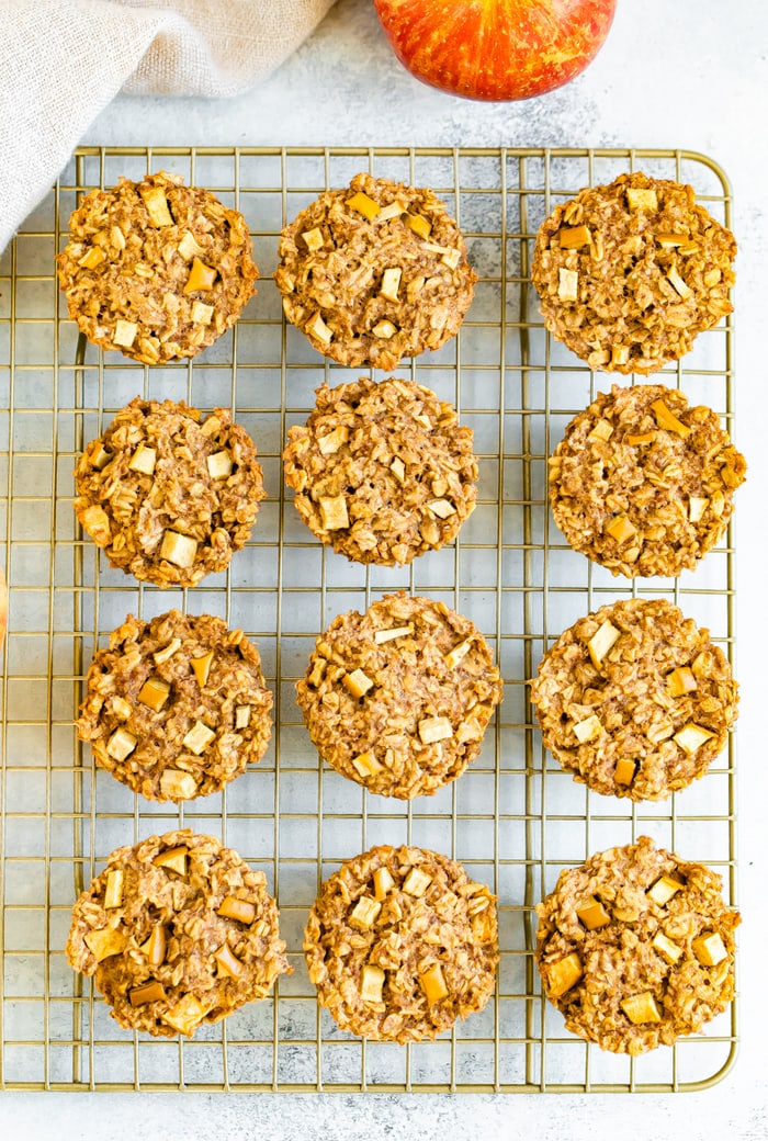 Apple cinnamon oatmeal cups on a gold cooling rack.