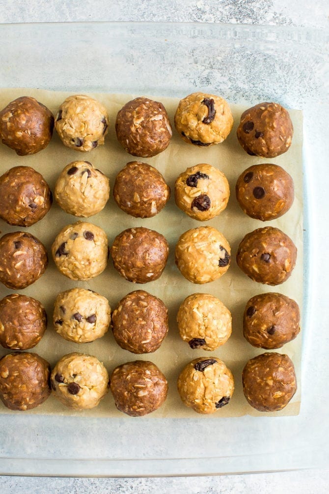 Parchment paper lined with 4 flavors of protein balls.