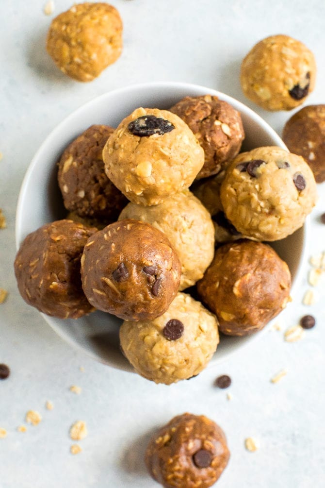 A bowl full of different flavors of protein balls.