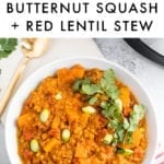 Bowl of slow cooker butternut squash and red lentil stew, topped with cilantro and green onions.