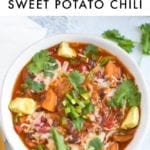 Slow cooker sweet potato and black bean vegetarian chili in a bowl topped with cilantro, cheese and jalapeño.