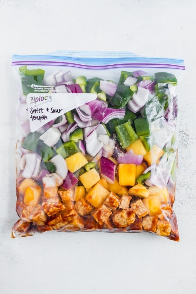 Freezer meal. Sweet and sour tempeh in a freezer bag with pineapple, peppers and onions.