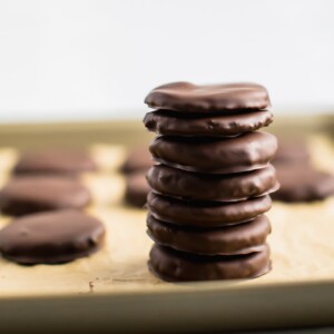 Stack of paleo thin mints on a baking sheet.