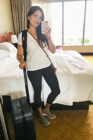Hotel mirror selfie of a woman without travel bloating.