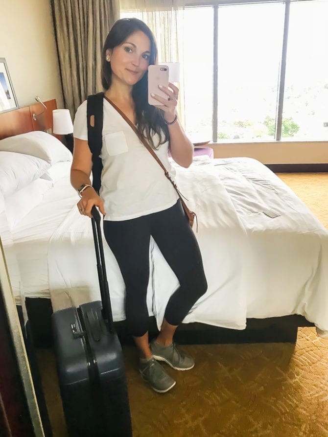 Hotel mirror selfie of a woman without travel bloating.