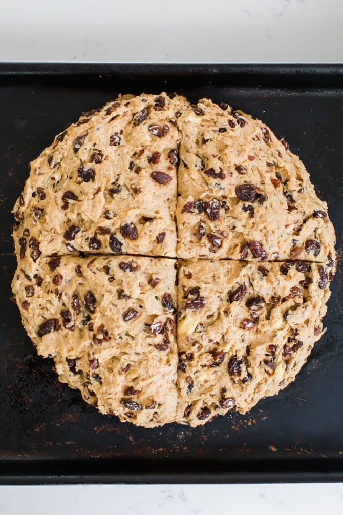 Irish soda bread wheat dough on a baking sheet.