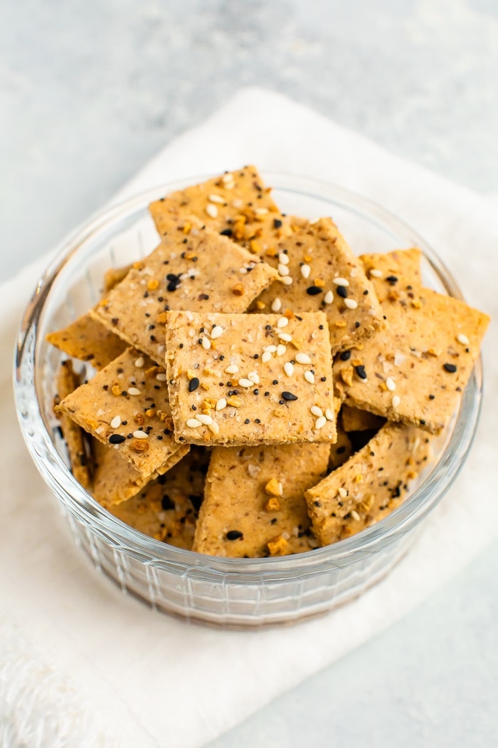 Bowl of homemade crackers topped with Everything But The Bagel Seasoning.