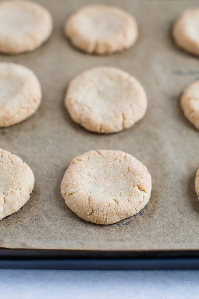 Almond flour shortbread cookies on a baking sheet with parchment paper for the homemade healthy tagalongs.