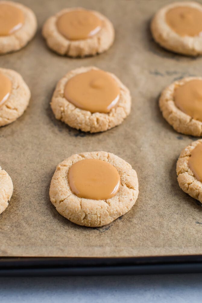 Almond flour shortbread cookies with a thumbprint filled with peanut butter. 