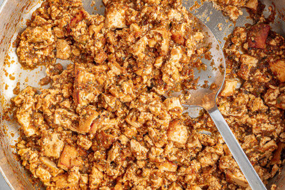 Sofritas in a skillet with a spoon.