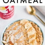 Bowl of cottage cheese protein oatmeal topped with sliced almonds, coconut flakes, banana, flax seeds and peanut butter. Cottage cheese container and spoon are in the background.