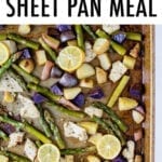 Lemon garlic sheet pan meal with chicken, potatoes and asparagus. Topped with lemon slices.