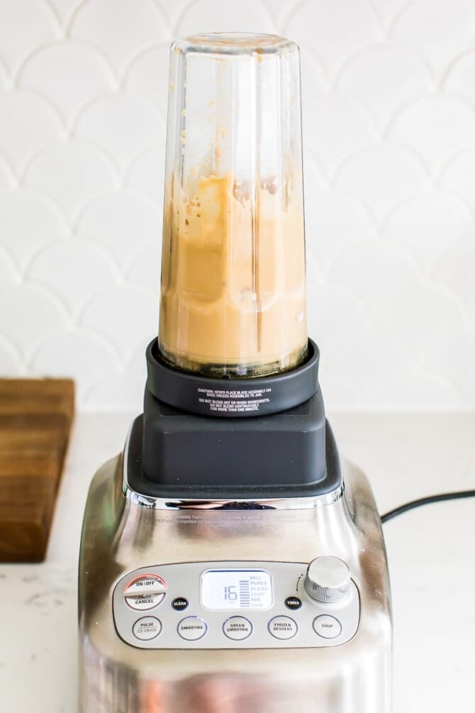 Almondmilk creamer ice cubes and cold brew being blended up in a blender. Frothy and creamy.